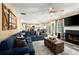 Spacious living room adjacent to dining area with a fireplace and comfortable seating at 423 Blackbird Way, Hampton, GA 30228