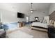 Expansive primary bedroom boasts a ceiling fan, a TV, and a sitting area at 423 Blackbird Way, Hampton, GA 30228