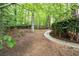 Spacious backyard featuring a walkway and mature trees surrounding the property at 1382 Benbrooke Nw Ln, Acworth, GA 30101