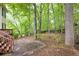 Patio and stairs leading up to a wooden deck in a backyard with mature trees at 1382 Benbrooke Nw Ln, Acworth, GA 30101
