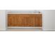 Basement wet bar with wood cabinets and sink with view of neutral carpet at 1382 Benbrooke Nw Ln, Acworth, GA 30101