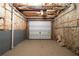 Unfinished basement featuring concrete floor, walls, and a garage door at 1382 Benbrooke Nw Ln, Acworth, GA 30101