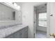 Bathroom with stylish vanity, marble countertop, mirror, and tiled floor at 1382 Benbrooke Nw Ln, Acworth, GA 30101