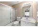 Bathroom featuring a bathtub and shower with glass door, toilet and vanity sink at 1382 Benbrooke Nw Ln, Acworth, GA 30101