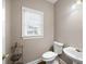 Half bath featuring updated fixtures and a window for natural light at 1382 Benbrooke Nw Ln, Acworth, GA 30101