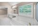 Bathroom with a tub, vanity, and window for natural light at 1382 Benbrooke Nw Ln, Acworth, GA 30101