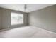Bedroom with ceiling fan, carpet, and window for natural light at 1382 Benbrooke Nw Ln, Acworth, GA 30101