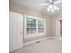 Bedroom features a ceiling fan, neutral carpet, and a view to the outside at 1382 Benbrooke Nw Ln, Acworth, GA 30101