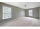 Spacious bedroom with neutral carpet, ceiling fan, and ample natural light from windows at 1382 Benbrooke Nw Ln, Acworth, GA 30101