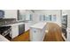 Bright kitchen features modern appliances, tile backsplash, and spacious island with hardwood floors at 1382 Benbrooke Nw Ln, Acworth, GA 30101