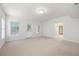 Bright, carpeted living room featuring windows, a back door, and an open floor plan at 1382 Benbrooke Nw Ln, Acworth, GA 30101