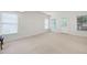 Large living room space with neutral carpet and many windows at 1382 Benbrooke Nw Ln, Acworth, GA 30101