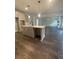 Bright kitchen featuring an island with a sink and wood-style flooring throughout the home at 171 Silvercrest Dr, Acworth, GA 30101