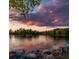 Gorgeous sunset view over the lake, with lush trees at 171 Silvercrest Dr, Acworth, GA 30101