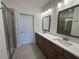The bathroom features double sinks, a walk-in shower, and neutral tile at 1802 Bonica Xing # 1802, Cumming, GA 30040
