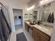 Bathroom with double sink vanity, framed mirrors, and walk-in closet at 1802 Bonica Xing # 1802, Cumming, GA 30040