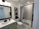 Bathroom with a white vanity, dark framed mirror, and combination tub and shower at 1802 Bonica Xing # 1802, Cumming, GA 30040