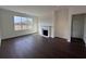 Spacious room features a cozy fireplace, natural light, and elegant hardwood floors at 1802 Bonica Xing # 1802, Cumming, GA 30040