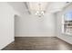 Elegant dining room with hardwood floors, coffered ceilings, and a modern chandelier at 1831 Lacebark Elm Way, Lawrenceville, GA 30045