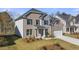 Inviting home with brick facade, a two-car garage and a lush green lawn at 1831 Lacebark Elm Way, Lawrenceville, GA 30045