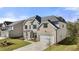 Beautiful home exterior with a manicured lawn, two-car garage and attractive landscaping at 1831 Lacebark Elm Way, Lawrenceville, GA 30045