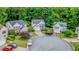 Aerial view of the white two-story home situated on a cul-de-sac and surrounded by lush greenery in a desirable neighborhood at 2022 Maple Ridge Nw Dr, Acworth, GA 30101
