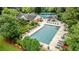 Aerial view of a community pool, clubhouse, and surrounding landscape at 2022 Maple Ridge Nw Dr, Acworth, GA 30101