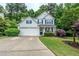 Charming two-story home with a two-car garage and well-manicured lawn at 2022 Maple Ridge Nw Dr, Acworth, GA 30101