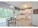 Bright kitchen with white cabinets, modern appliances, and sliding glass door to backyard at 2022 Maple Ridge Nw Dr, Acworth, GA 30101