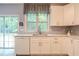 Updated kitchen features white cabinets, quartz countertops, stainless steel dishwasher, and a large window with natural light at 2022 Maple Ridge Nw Dr, Acworth, GA 30101