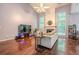 Bright living room featuring hardwood floors, high ceilings, fireplace, and large windows offering natural light at 2022 Maple Ridge Nw Dr, Acworth, GA 30101