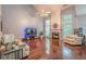 Spacious living room featuring vaulted ceiling, fireplace, large windows, and hardwood floors at 2022 Maple Ridge Nw Dr, Acworth, GA 30101