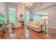 Bright living room with hardwood floors, high ceilings, fireplace, and natural light from the oversized windows at 2022 Maple Ridge Nw Dr, Acworth, GA 30101