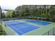 Well-maintained blue tennis courts within a fenced community space at 2022 Maple Ridge Nw Dr, Acworth, GA 30101