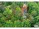 Expansive wooded property with a modern house, driveway and swimming pool, all bordered by a red property line at 61 Sherwood Se Ln, Marietta, GA 30067