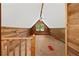 Attic area featuring wood paneling, a window, and sloped ceilings at 61 Sherwood Se Ln, Marietta, GA 30067