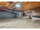Unfinished basement with exposed wooden ceiling, concrete floors, and utilities at 61 Sherwood Se Ln, Marietta, GA 30067