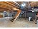 Spacious unfinished basement with stairs, concrete floor, and exposed wooden ceiling at 61 Sherwood Se Ln, Marietta, GA 30067