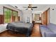 Bedroom featuring hardwood floors, natural light from multiple windows, and a ceiling fan at 61 Sherwood Se Ln, Marietta, GA 30067