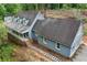 View of charming house with attached two-car garage and a covered porch. House is surrounded by trees at 61 Sherwood Se Ln, Marietta, GA 30067