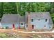 Two-story home with blue siding, a brick chimney, and an adjacent structure at 61 Sherwood Se Ln, Marietta, GA 30067