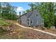 Two-story home with blue siding, white trim, and surrounded by mature trees at 61 Sherwood Se Ln, Marietta, GA 30067