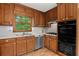 Functional kitchen showcasing wood cabinets, stainless steel appliances, and a bright window over the sink at 61 Sherwood Se Ln, Marietta, GA 30067