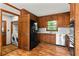Well-equipped kitchen featuring wood cabinetry, black appliances, and a convenient laundry area at 61 Sherwood Se Ln, Marietta, GA 30067