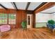 Inviting living space with hardwood floors, wood paneling, and an open layout connecting to the dining room at 61 Sherwood Se Ln, Marietta, GA 30067
