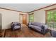 Inviting living room with hardwood floors, chairs, and windows offering views of the outdoor greenery at 61 Sherwood Se Ln, Marietta, GA 30067