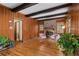 Charming living room with wood paneling, exposed beams, a brick fireplace, and hardwood floors at 61 Sherwood Se Ln, Marietta, GA 30067