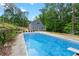 Backyard in-ground pool with patio and a clear view of the two-story home at 61 Sherwood Se Ln, Marietta, GA 30067