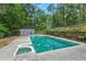 Backyard in-ground pool with stone wall feature and pool house in a wooded setting at 61 Sherwood Se Ln, Marietta, GA 30067