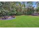 Secluded backyard featuring a fire pit, seating area, trampoline and level lawn for outdoor activities at 305 Montevallo Dr, Atlanta, GA 30342